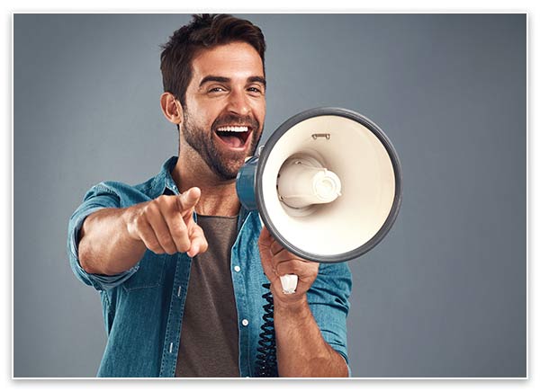 Image of a man smiling and pointing at you with a bull horn in his hand